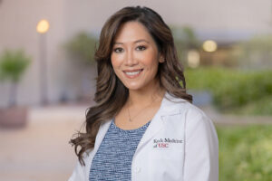 Cynthia Tsay, PA-C, stands outside and smiles.